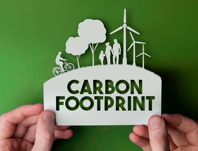 Human Hand Holding A Note Which Representing The Carbon Footprint Concept.